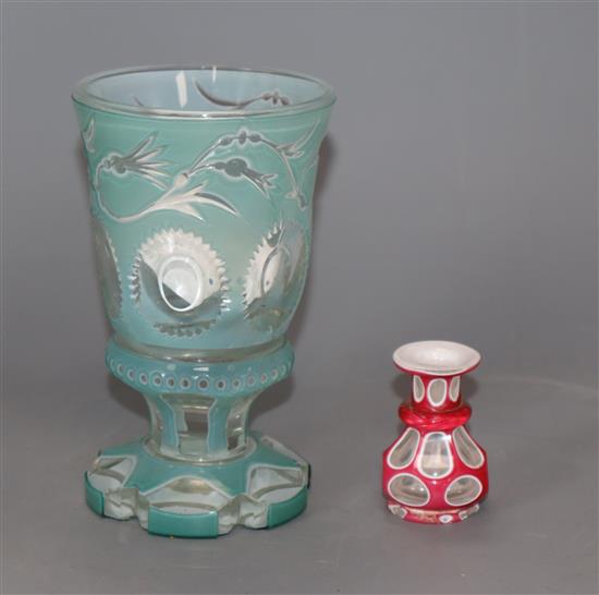 A 19th century Bohemian turquoise and white overlaid glass goblet and red and white overlaid glass miniature vase beaker 14cm